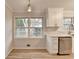 Bright kitchen featuring white cabinets, neutral countertops, and stainless steel appliances at 1758 N Springs Dr, Atlanta, GA 30338