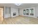 Spacious living room with fireplace, hardwood floors, built-in shelving at 1758 N Springs Dr, Atlanta, GA 30338