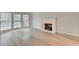 Sun-drenched living room with a decorative white fireplace and hardwood floors at 1758 N Springs Dr, Atlanta, GA 30338
