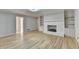 Bright living room featuring a painted brick fireplace and built-in shelving at 1758 N Springs Dr, Atlanta, GA 30338