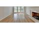 Bright living room featuring large windows and a white fireplace with wooden floors at 1758 N Springs Dr, Atlanta, GA 30338