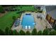 Aerial view of backyard oasis showcasing the sparkling pool, luxurious lounge chairs, and meticulously landscaped yard at 2377 Kesgrove Way, Buford, GA 30518