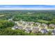 Expansive aerial view of a residential community surrounded by lush green trees and rolling hills at 2377 Kesgrove Way, Buford, GA 30518
