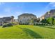 Large backyard with green grass, beautiful trees, pool, and well-maintained landscaping at 2377 Kesgrove Way, Buford, GA 30518