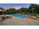Inviting backyard pool and patio area with comfortable seating, perfect for relaxing and enjoying the outdoors at 2377 Kesgrove Way, Buford, GA 30518