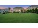 Expansive backyard featuring lush green grass, mature trees, and manicured shrubs creating a private oasis at 2377 Kesgrove Way, Buford, GA 30518