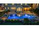 Backyard oasis featuring a luxurious pool with a tanning ledge, hot tub, and ample seating for entertaining at 2377 Kesgrove Way, Buford, GA 30518