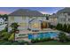 Entertainer's backyard featuring a pool, spa, covered patio, and beautifully landscaped grounds at 2377 Kesgrove Way, Buford, GA 30518