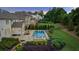 Private backyard oasis with a sparkling pool, spa, stone patio, and mature trees at 2377 Kesgrove Way, Buford, GA 30518