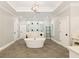 Stunning bathroom featuring a soaking tub, glass shower with multiple shower heads, and neutral color palette at 2377 Kesgrove Way, Buford, GA 30518