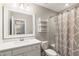 Bright bathroom featuring a shower with patterned curtain and a vanity with a modern sink at 2377 Kesgrove Way, Buford, GA 30518