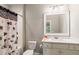 Stylish bathroom featuring a modern vanity, sleek fixtures, and a shower with a patterned curtain at 2377 Kesgrove Way, Buford, GA 30518