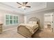 Bedroom with trey ceiling, a shuttered window, and walk-in closet at 2377 Kesgrove Way, Buford, GA 30518