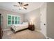Serene bedroom with neutral tones, plush carpet, and natural light streaming through the window at 2377 Kesgrove Way, Buford, GA 30518