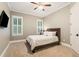 Cozy bedroom with carpet flooring, ceiling fan, and ample natural light at 2377 Kesgrove Way, Buford, GA 30518