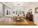 Formal dining room with hardwood floors, white wainscoting, and a modern lighting fixture at 2377 Kesgrove Way, Buford, GA 30518