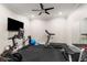 Modern home exercise room equipped with a treadmill, stationary bike, and weight training equipment at 2377 Kesgrove Way, Buford, GA 30518