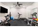 Modern home exercise room equipped with a treadmill, stationary bike, weight training equipment, and a mirror at 2377 Kesgrove Way, Buford, GA 30518