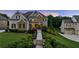 Beautiful home featuring manicured landscaping, stone accents, and a charming front porch at 2377 Kesgrove Way, Buford, GA 30518
