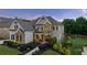 Stunning exterior elevation of a two-story home with stone accents, lush landscaping, and a welcoming entrance at 2377 Kesgrove Way, Buford, GA 30518