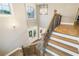 Grand foyer with staircase and hardwood floors viewed from above, bathed in natural light at 2377 Kesgrove Way, Buford, GA 30518