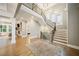 Grand foyer with hardwood floors, staircase with iron railing, and soaring ceilings at 2377 Kesgrove Way, Buford, GA 30518