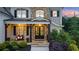 Charming home featuring a stone facade, covered porch with wood beams, and lush landscaping at 2377 Kesgrove Way, Buford, GA 30518