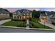 Beautiful home showcasing lush landscaping, manicured lawn, and a welcoming walkway leading to the front door at 2377 Kesgrove Way, Buford, GA 30518