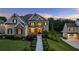 Elegant home with stone and siding exterior, complemented by a well-manicured lawn and inviting front porch at 2377 Kesgrove Way, Buford, GA 30518