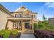 Charming front porch with stone accents, comfortable seating, and elegant design at 2377 Kesgrove Way, Buford, GA 30518