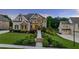 Charming two-story home featuring stone accents, well-manicured landscaping, and a welcoming front porch at 2377 Kesgrove Way, Buford, GA 30518
