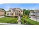 Beautifully landscaped front yard with lush greenery, stone accents, and manicured lawn at 2377 Kesgrove Way, Buford, GA 30518