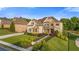 Beautifully landscaped front yard with lush greenery, stone accents, and manicured lawn at 2377 Kesgrove Way, Buford, GA 30518