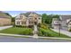 Beautifully landscaped front yard with lush greenery, stone accents, and manicured lawn at 2377 Kesgrove Way, Buford, GA 30518