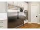 Stainless steel refrigerator and double ovens with white cabinets provide a modern kitchen appeal at 2377 Kesgrove Way, Buford, GA 30518