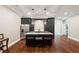 Modern kitchen with stainless steel appliances, marble countertops, and a spacious island with seating at 2377 Kesgrove Way, Buford, GA 30518