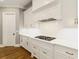 Elegant kitchen with white cabinets, quartz countertops, gas range, and stainless steel hardware at 2377 Kesgrove Way, Buford, GA 30518