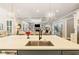 Kitchen island with stainless steel sink, faucet and seating, open to the living room with fireplace at 2377 Kesgrove Way, Buford, GA 30518