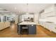 Large kitchen with center island and bar, connecting to dining area and stainless steel appliances at 2377 Kesgrove Way, Buford, GA 30518