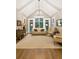 Bright living room featuring vaulted ceilings, a modern chandelier, and hardwood floors at 2377 Kesgrove Way, Buford, GA 30518