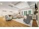 Inviting living room with a coffered ceiling, hardwood floors, and an open layout at 2377 Kesgrove Way, Buford, GA 30518