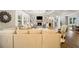 Open living room featuring a fireplace, built-in bookshelves, and hardwood floors at 2377 Kesgrove Way, Buford, GA 30518
