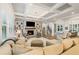 Inviting living room with coffered ceiling, fireplace, and view to the dining room at 2377 Kesgrove Way, Buford, GA 30518