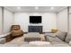 Cozy living room features a large TV and comfortable seating, perfect for relaxing and entertaining at 2377 Kesgrove Way, Buford, GA 30518