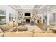 Spacious living room with coffered ceiling, a stone fireplace, and open concept design at 2377 Kesgrove Way, Buford, GA 30518