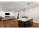 Open-concept living space with a modern kitchen, comfortable seating, and a TV area, perfect for entertaining at 2377 Kesgrove Way, Buford, GA 30518