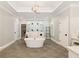 A luxurious main bathroom featuring a soaking tub and huge walk-in shower at 2377 Kesgrove Way, Buford, GA 30518