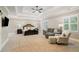 Spacious main bedroom boasts sitting area, tray ceilings, ceiling fan, and bright shuttered windows at 2377 Kesgrove Way, Buford, GA 30518