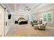 Spacious primary bedroom with trey ceiling, sitting area, and large windows at 2377 Kesgrove Way, Buford, GA 30518