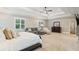 Large, open main bedroom with sitting area, lots of natural light, and access to ensuite bathroom at 2377 Kesgrove Way, Buford, GA 30518